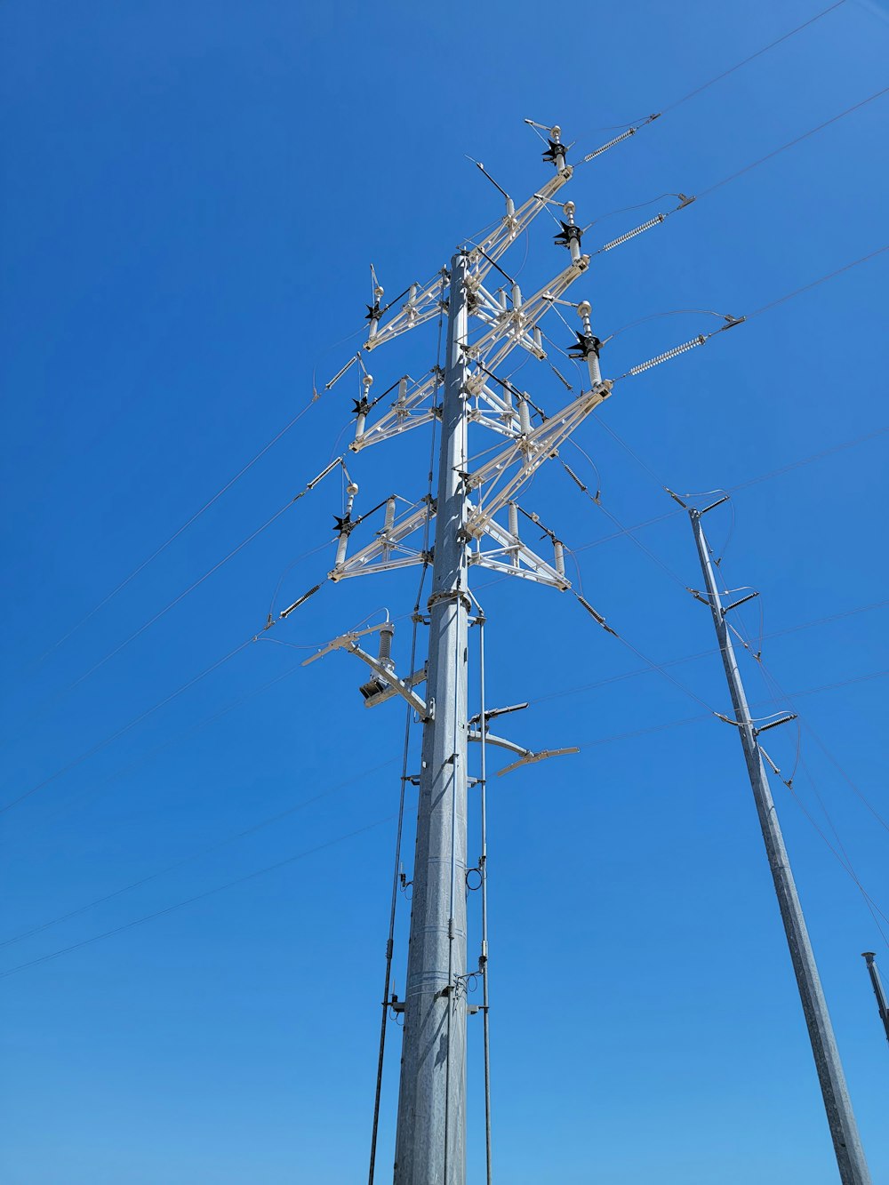 a tall metal pole with lots of wires on top of it