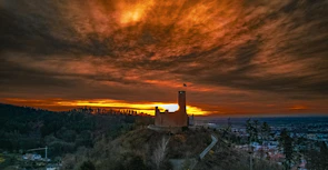 An ancient castle silhouetted against a fiery sunset, hinting at historical intrigue.