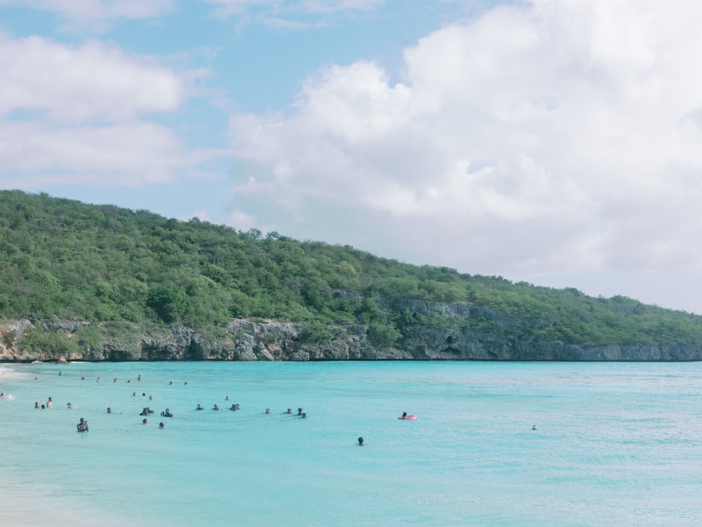 a group of people swimming in the ocean