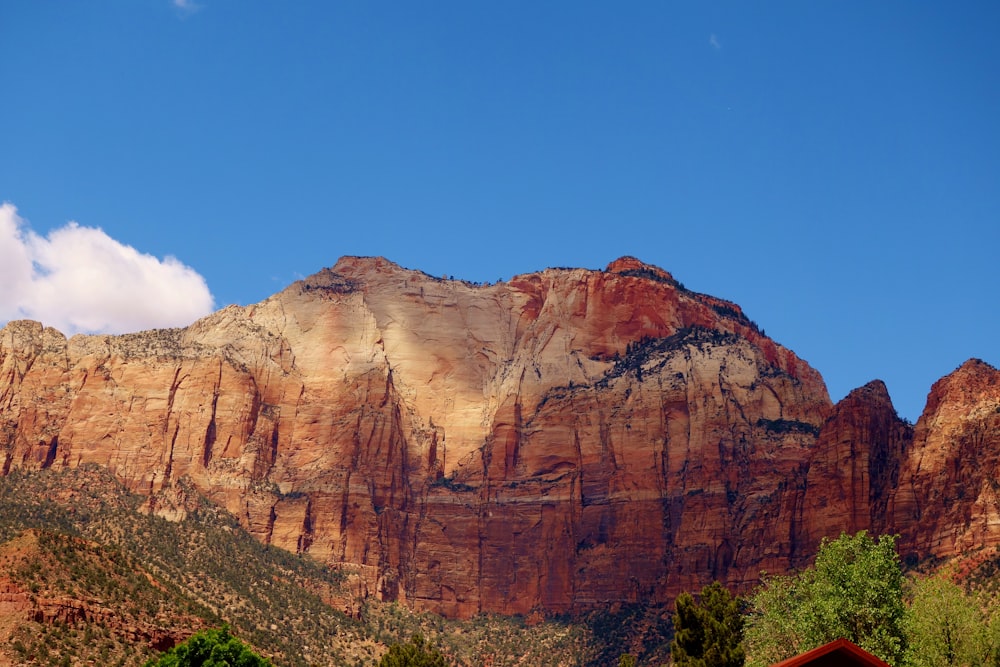 a mountain range with a house in the foreground