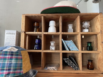 Engraved wooden coasters and wall plaques arranged neatly on a shelf