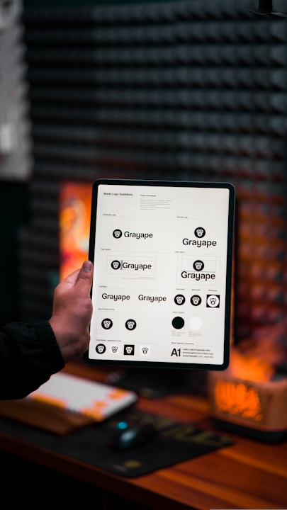 a person holding up a tablet with a bunch of buttons on it