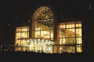 Compact canopy light illuminating a sleek commercial storefront entrance.
