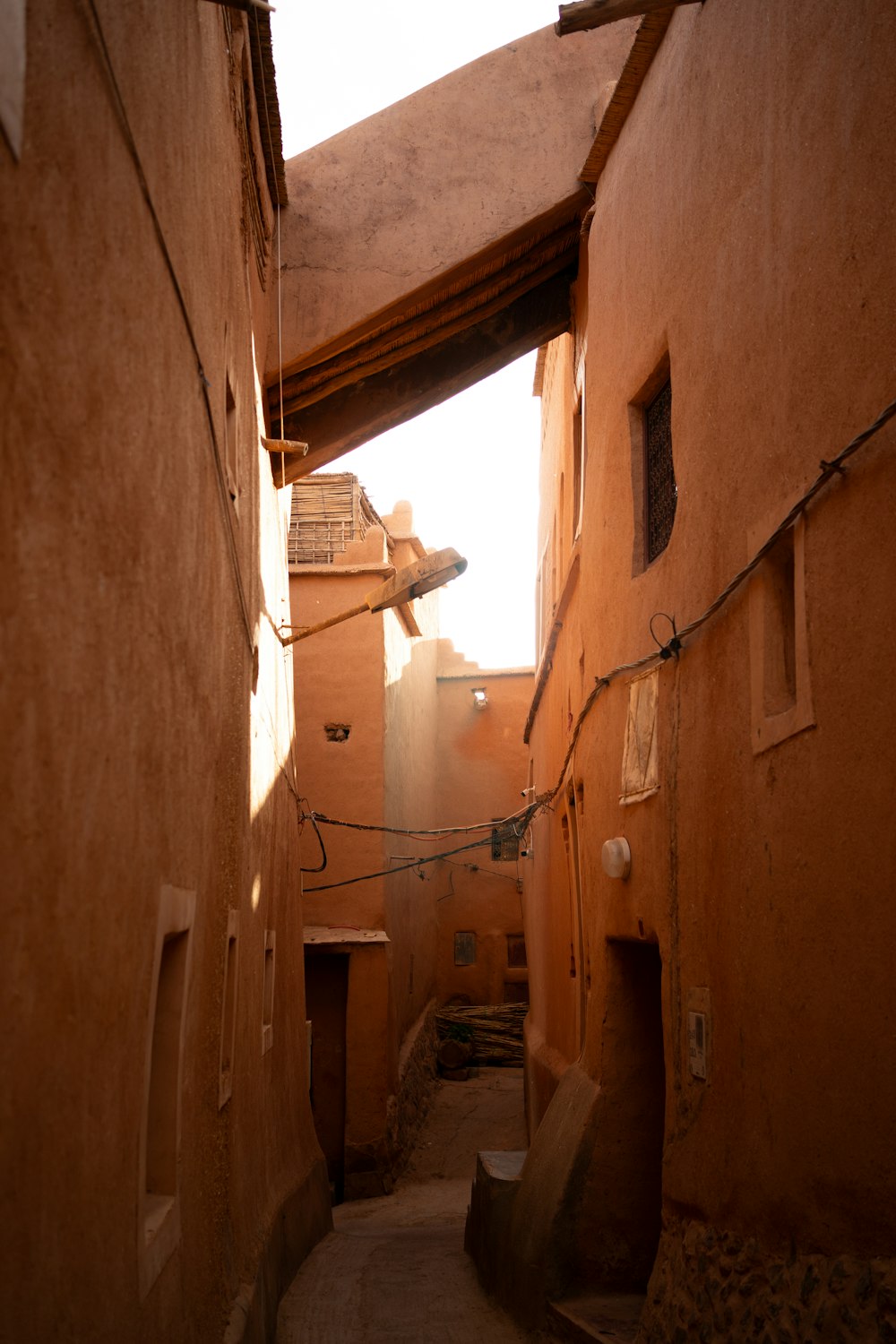 a narrow alley with a sign on the side of it