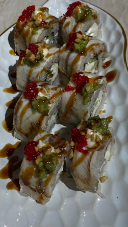A vibrant plate of sushi rolls with colorful toppings.