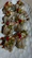 A vibrant plate of assorted sushi rolls with colorful garnishes on a wooden table.