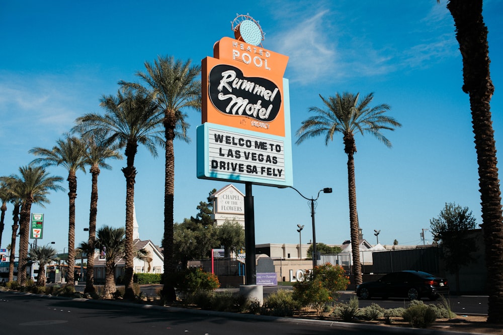 a sign for a restaurant with palm trees in the background