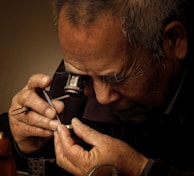 Close-up of a quality inspector examining intricate handicraft details