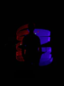 Streamer silhouette against a backdrop of pulsating red and black neon shapes.