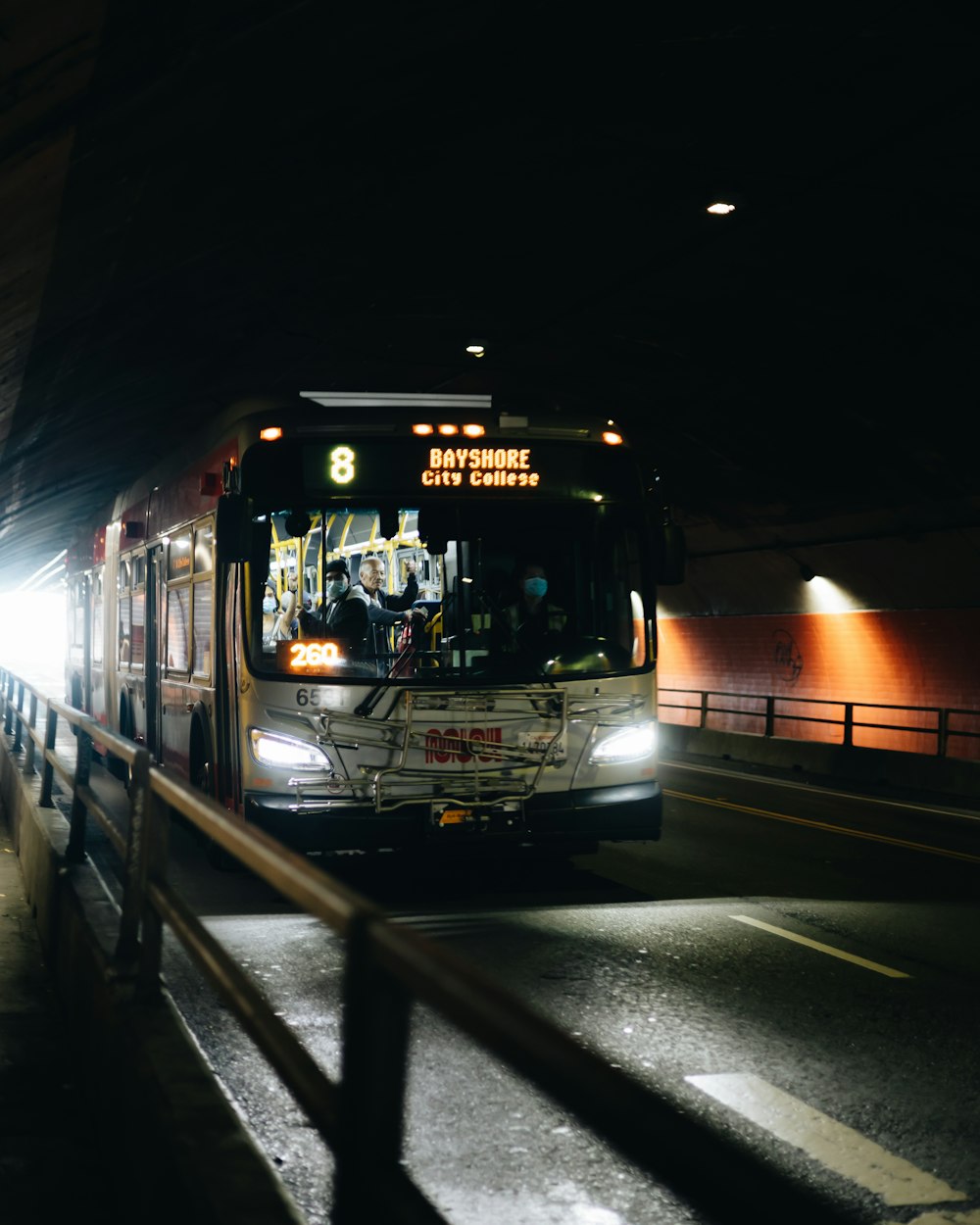 a bus driving down a street at night