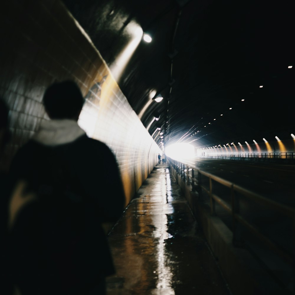a blurry photo of a person walking in a tunnel