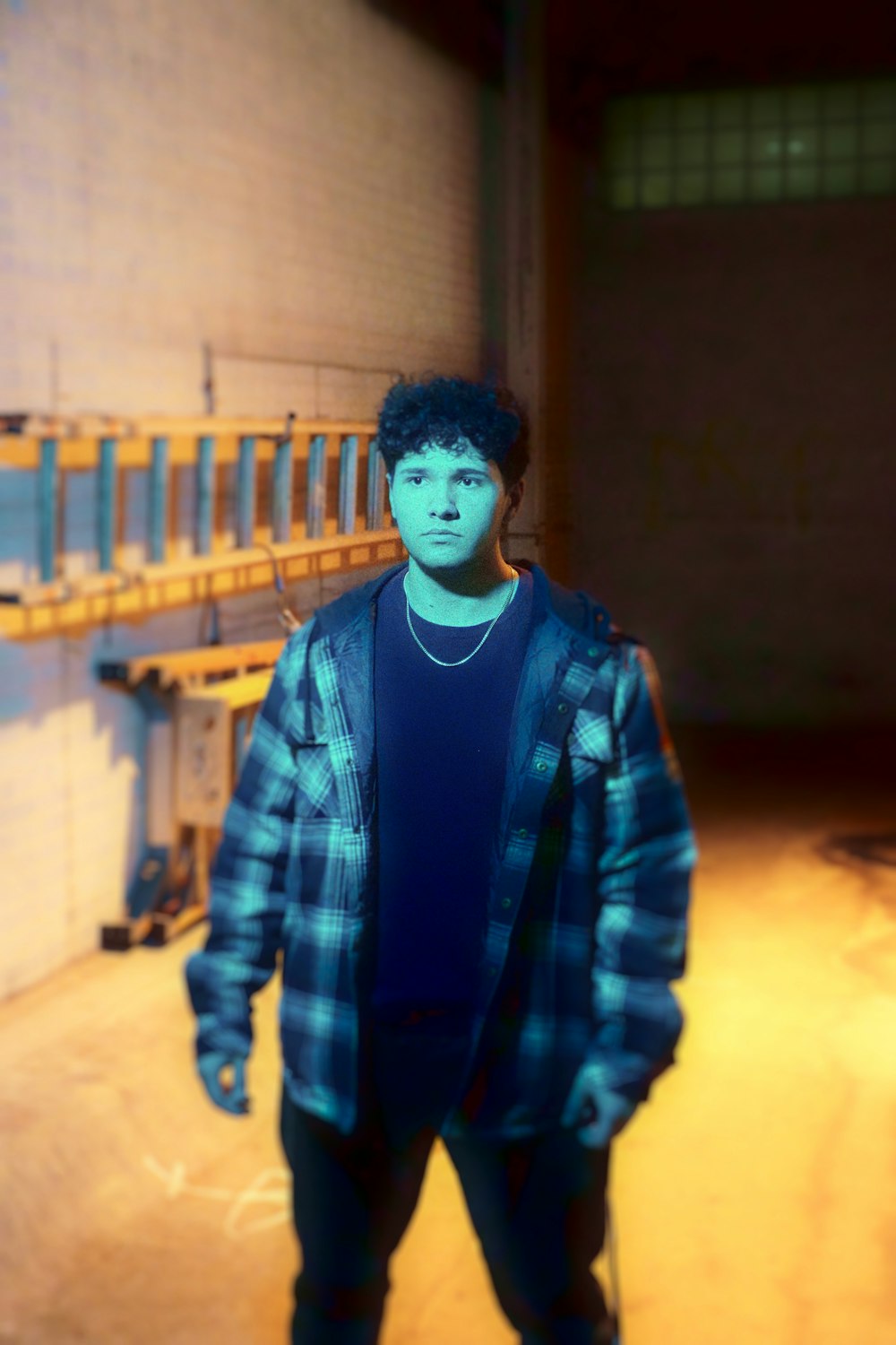 a man standing in a room with a skateboard