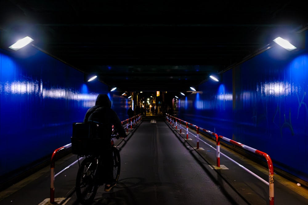 a person riding a bike in a tunnel