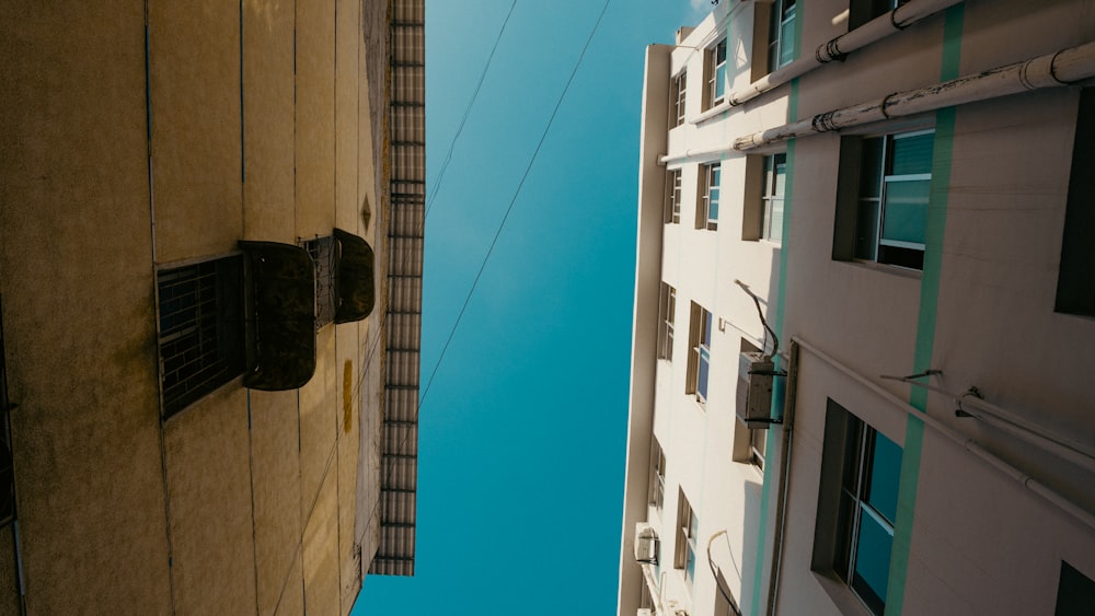 looking up at a tall building with a sky background