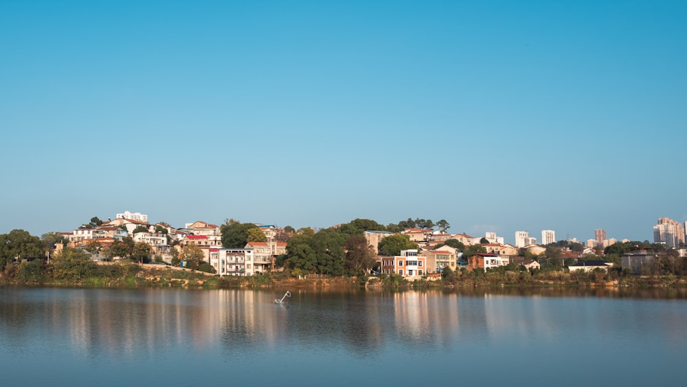 a body of water with a city in the background