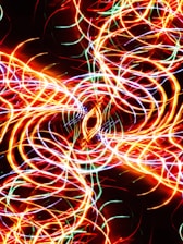 Abstract digital waveform glowing in neon colors against a dark background.