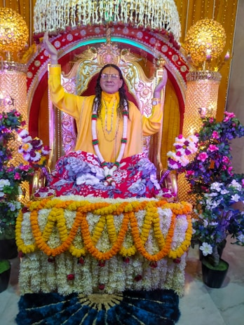 A regal Maharaja in traditional attire seated on an ornate throne, bathed in warm golden light.