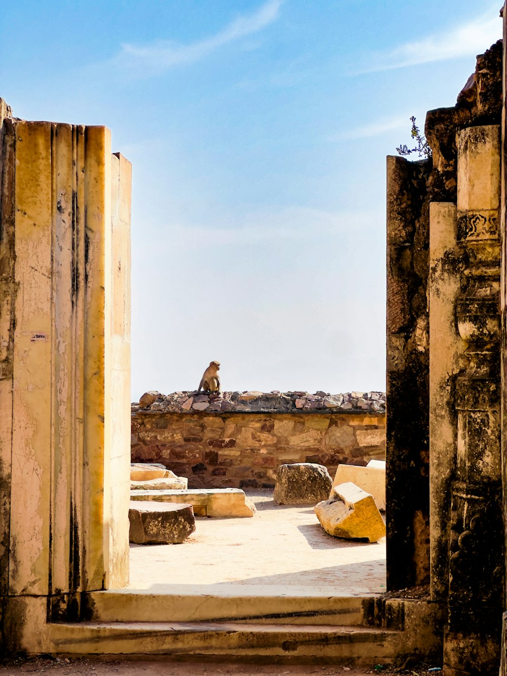 a man sitting on top of a stone structure