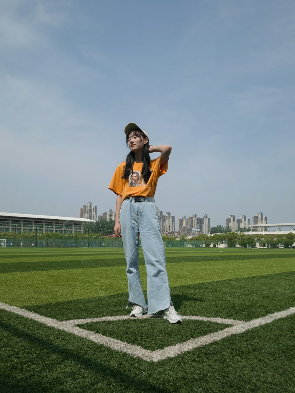a woman standing on top of a baseball field