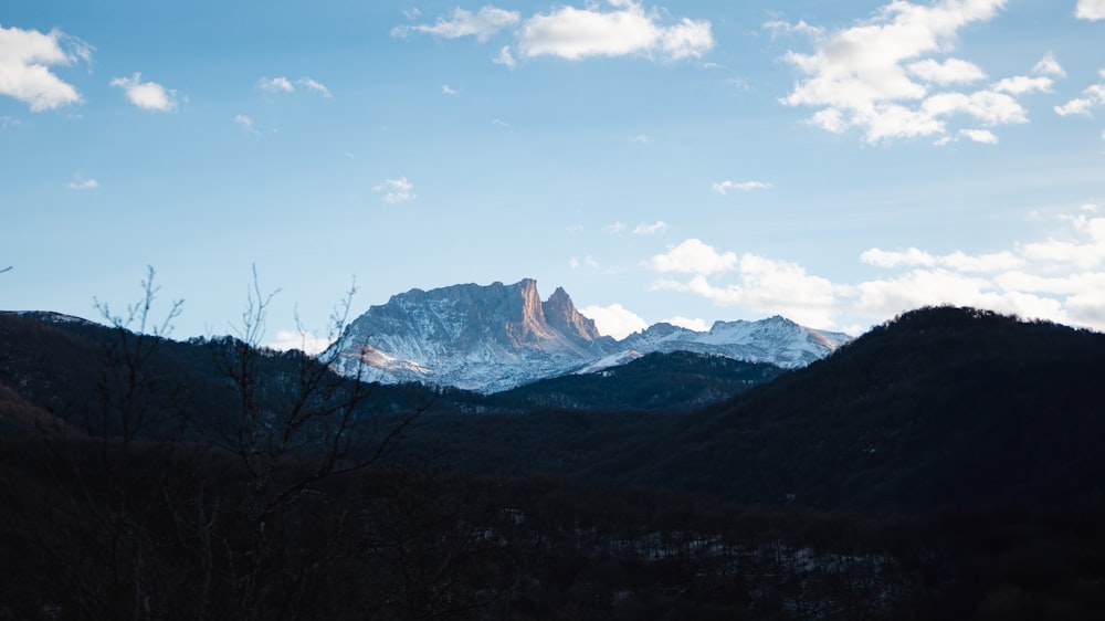 a view of a mountain range with clouds in the sky