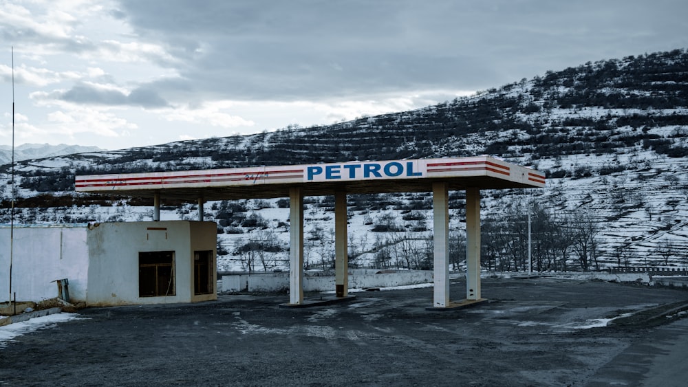 a gas station with a mountain in the background