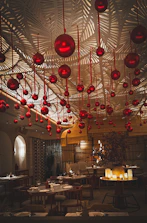 Cozy dining area with red accents and soft lighting reflecting Asian modern design.