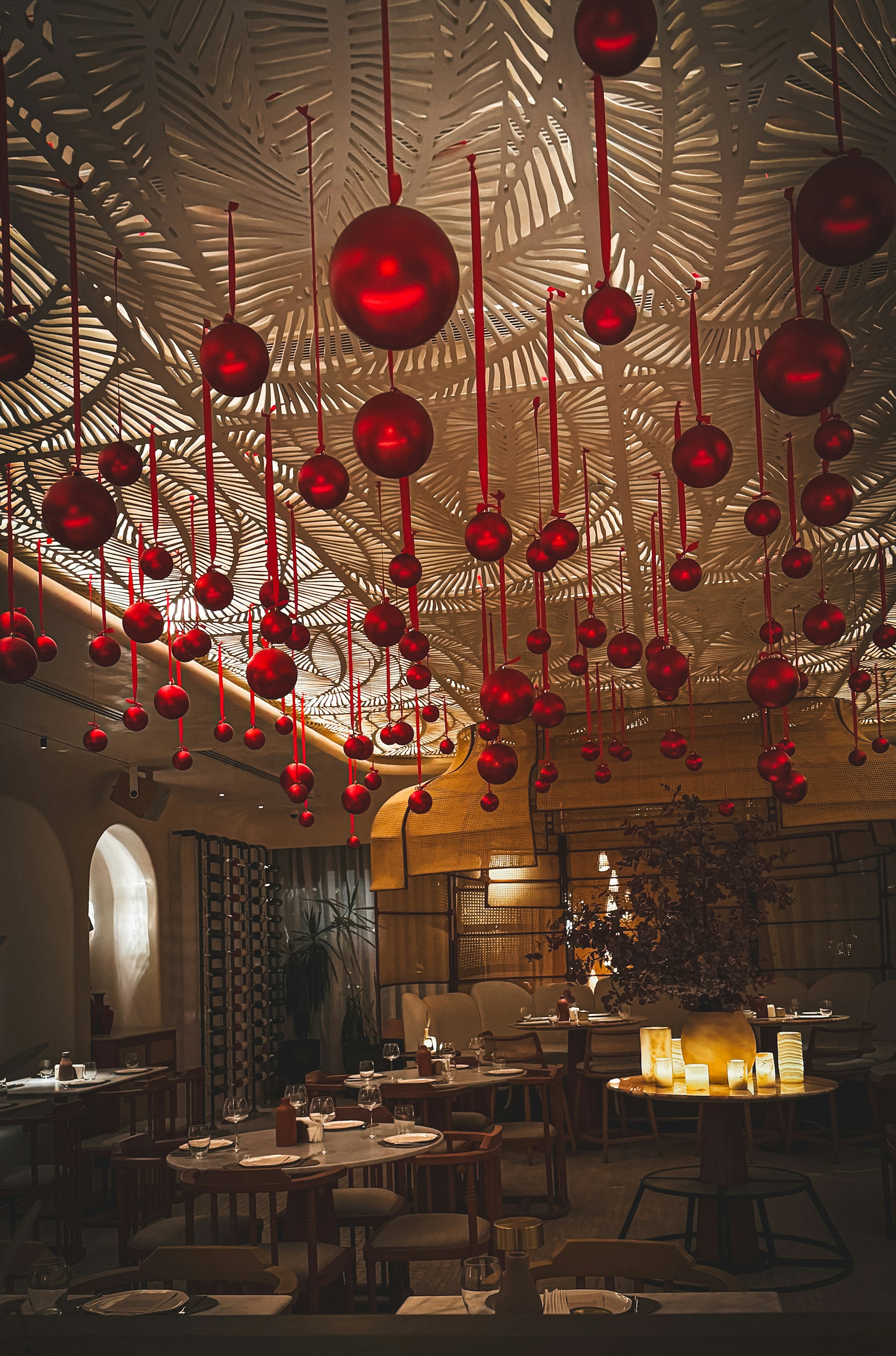 A warm, inviting dining setting with rich red and golden decor, featuring a table set for a luxurious kebab feast.