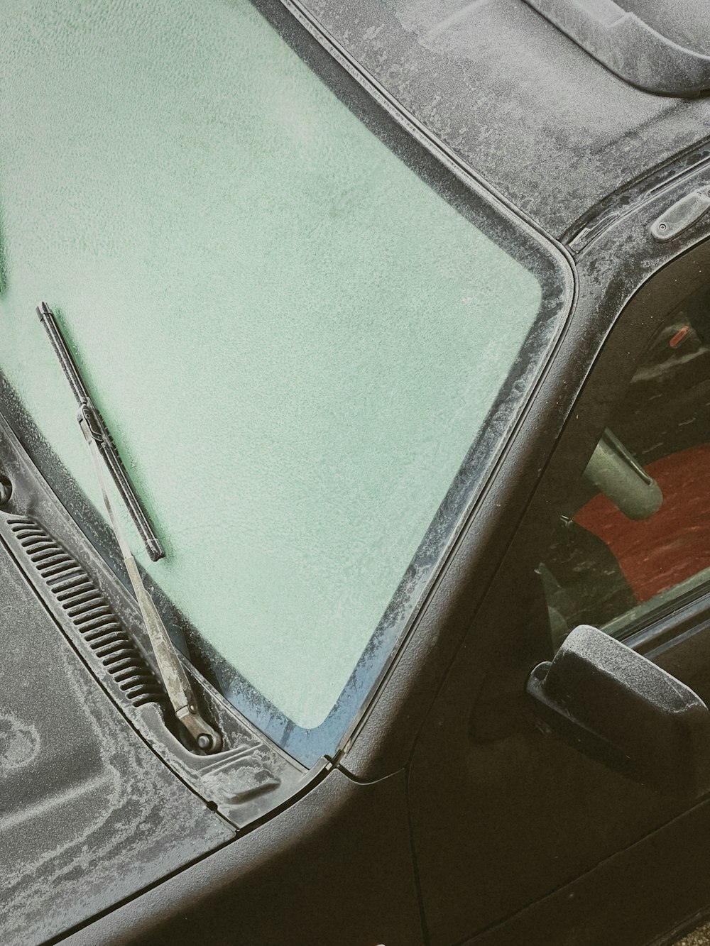 the windshield of a car that has been covered in ice