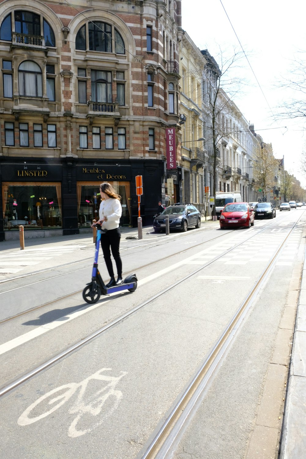 una mujer montando un scooter en una calle de la ciudad