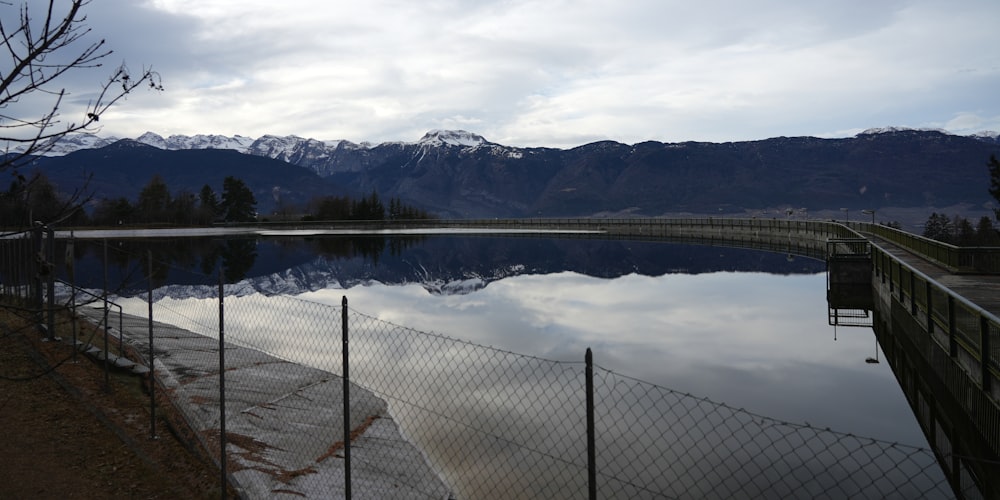a large body of water sitting next to a fence