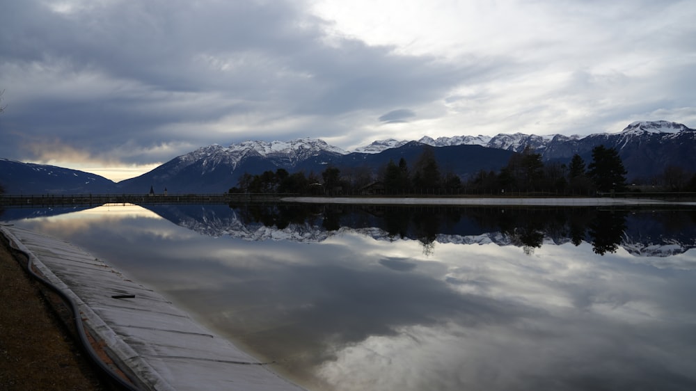 a body of water with mountains in the background