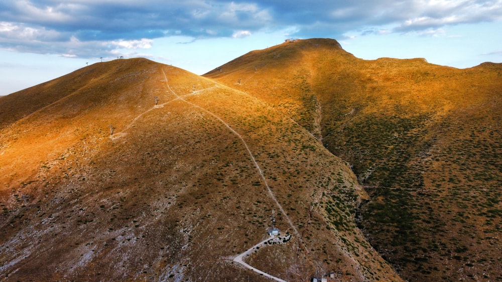 an aerial view of a mountain with a road going through it