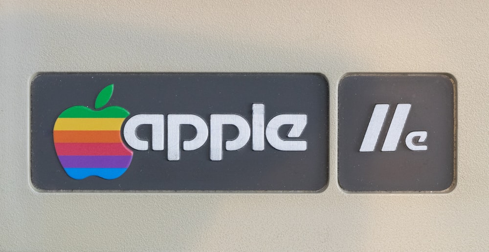 a close up of a sign with an apple logo