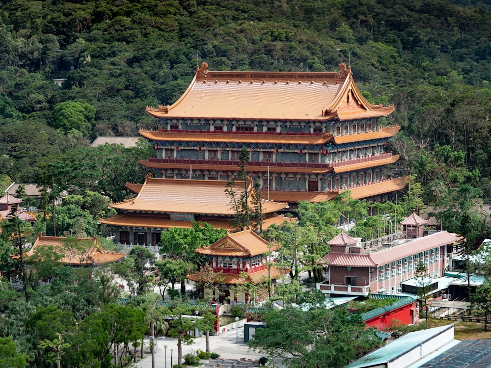 a large building sitting on top of a lush green hillside