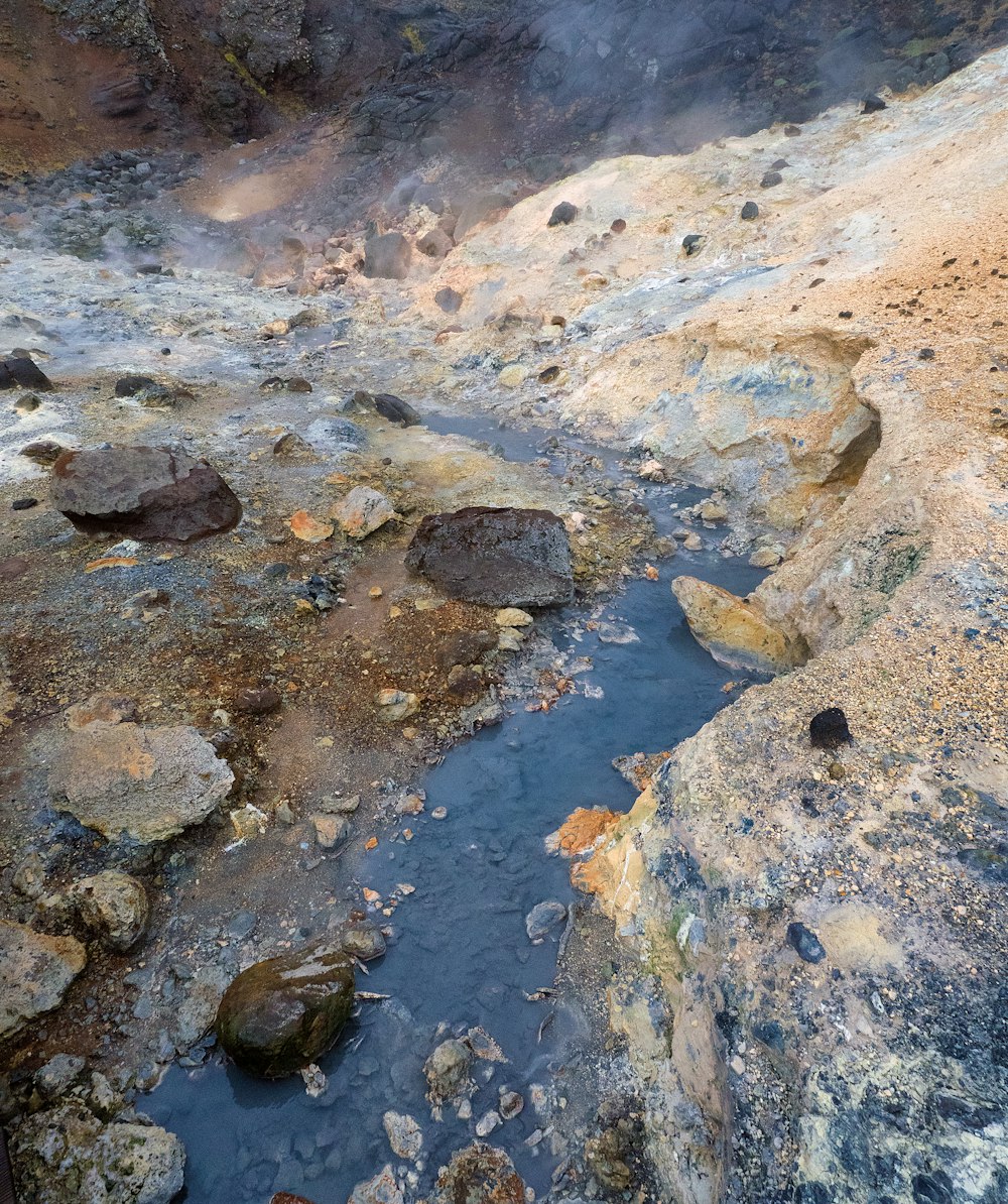 a small stream of water running through a rocky area