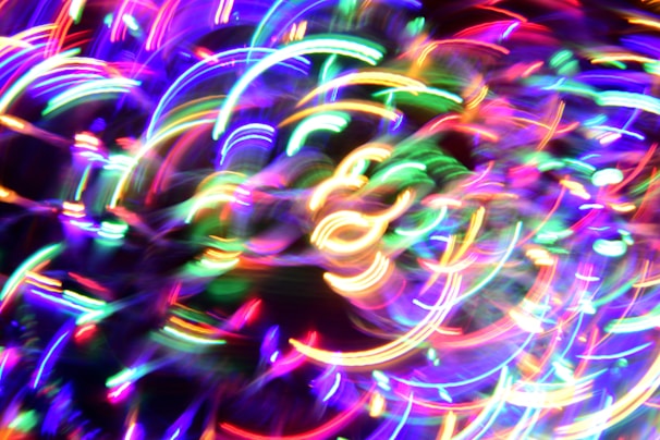 Creative typography formed by swirling neon lines on a deep black background