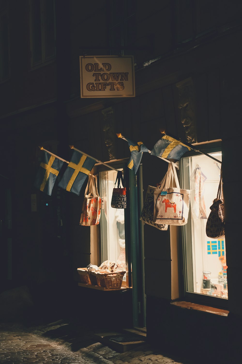 a store front with flags hanging from it's windows