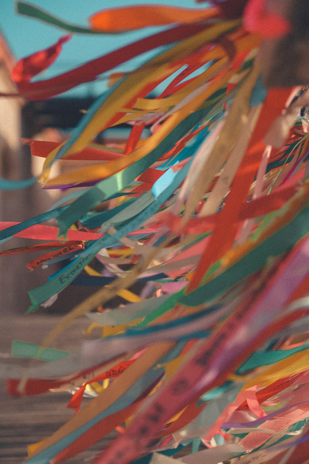 a bunch of colorful streamers hanging from a ceiling