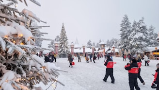 A festive winter scene with snowflakes gently falling over decorated trees and cheerful families enjoying the holiday atmosphere.