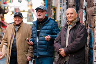 a group of three men standing next to each other
