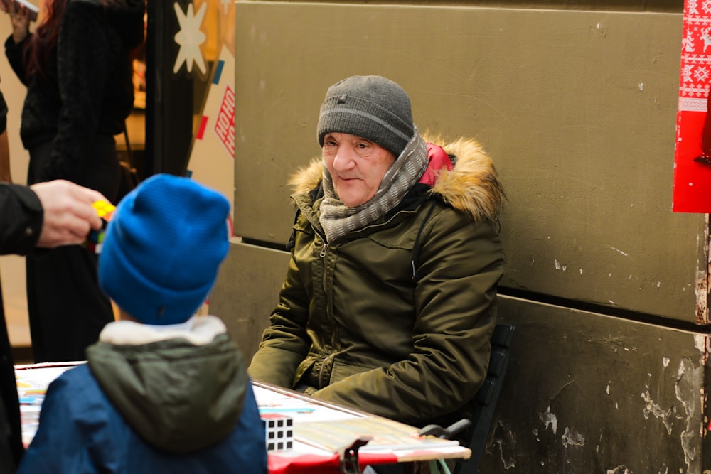 a man sitting at a table with a child