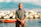 Photo of a cheerful man in casual clothes with the ocean and cliffs in the background at Tata Shelly Beach.