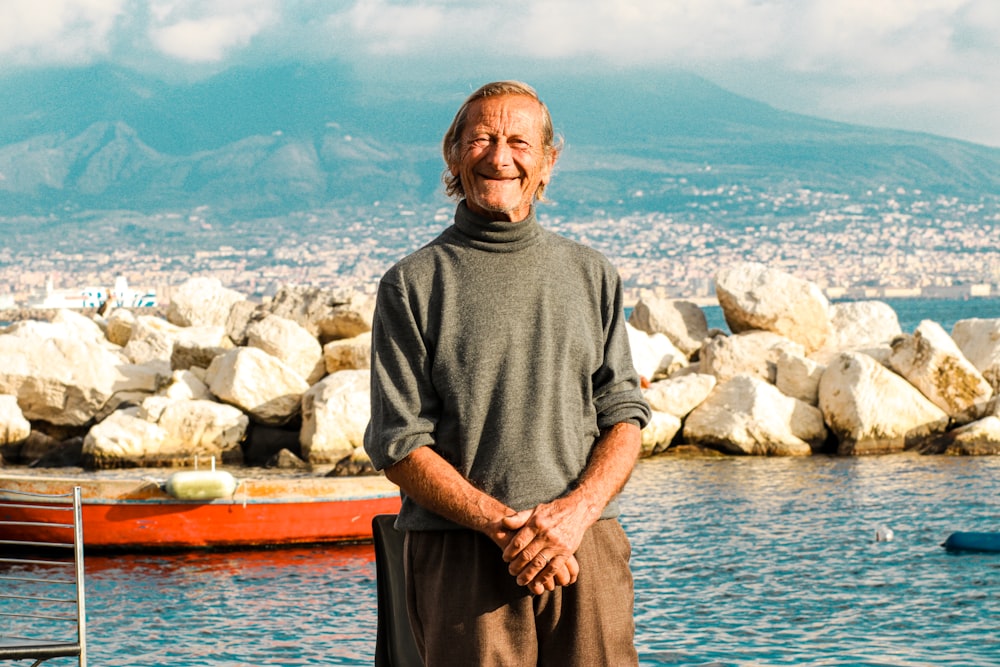 a man standing in front of a body of water