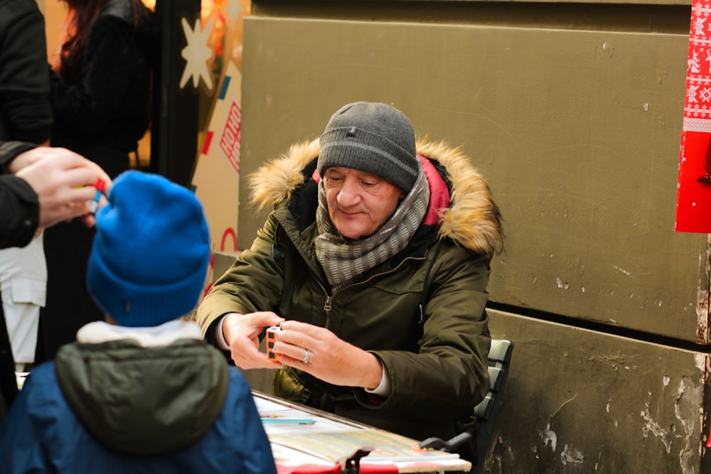 a woman sitting at a table with a child