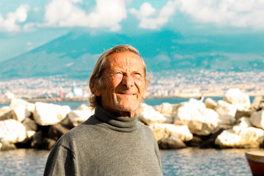 a man standing in front of a body of water