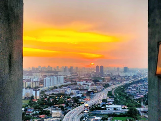 A vibrant travel photo capturing a sunset over a bustling cityscape.
