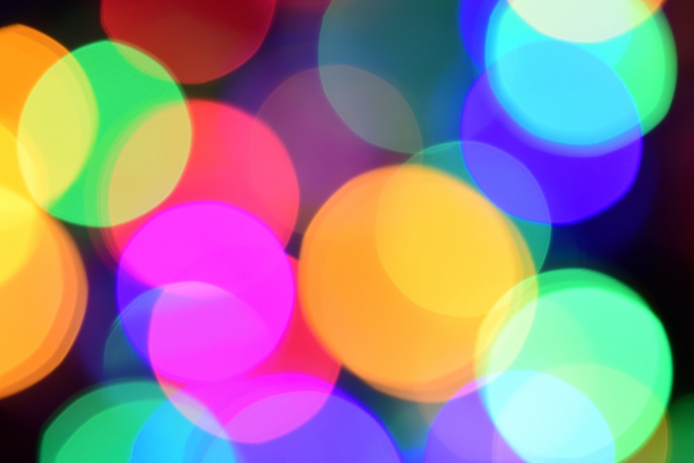 a blurry photo of colorful lights on a black background