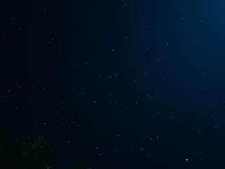 A tranquil blue night sky with constellations forming tarot symbols