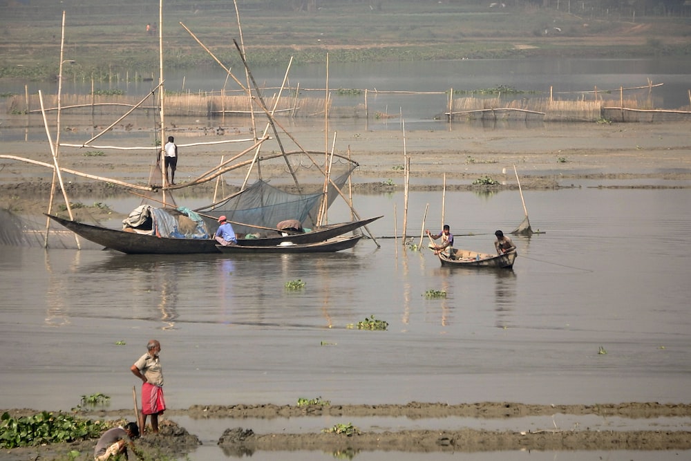 a group of people on small boats in a body of water