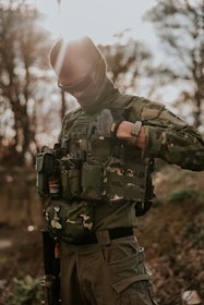 a man in a camouflage outfit holding a camera